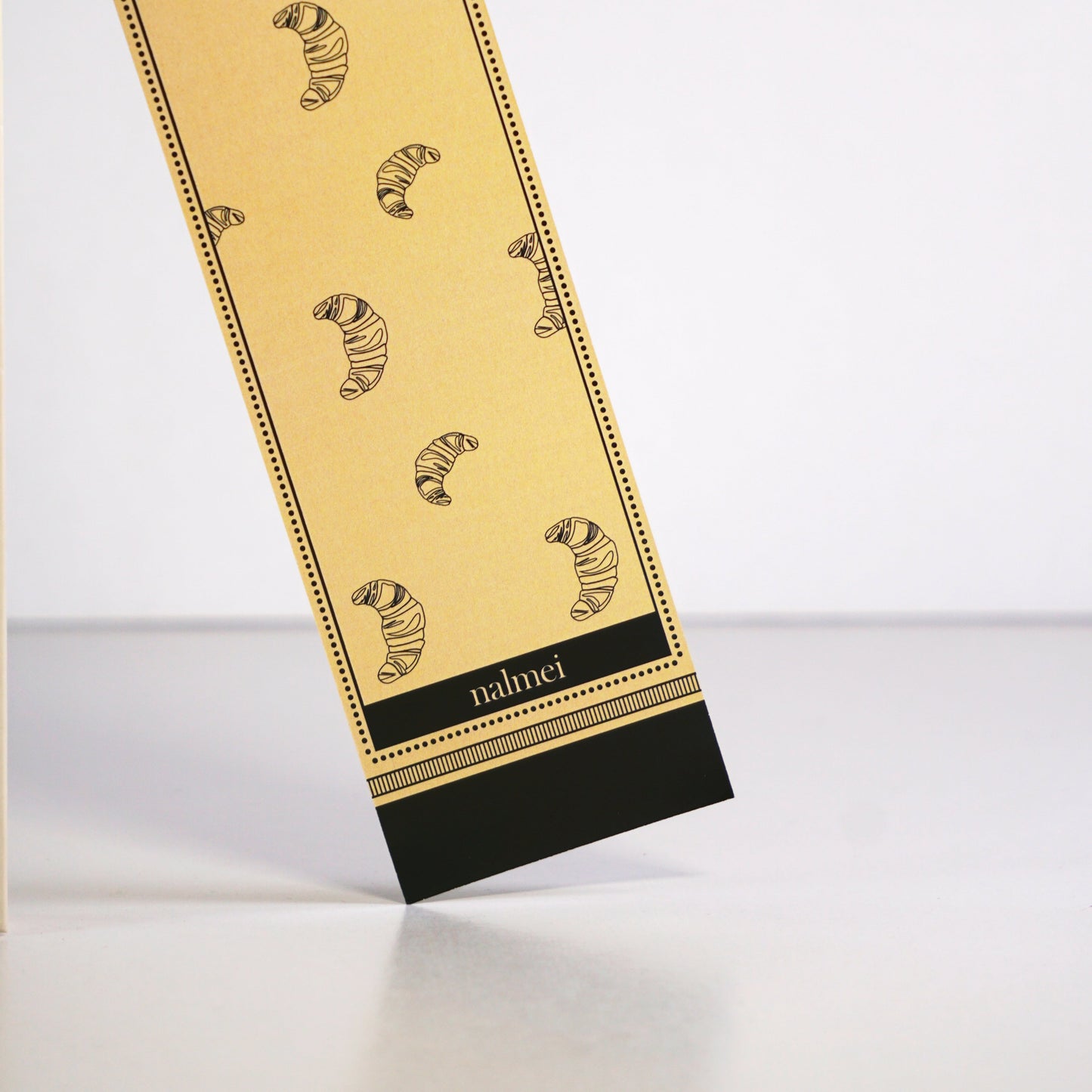 Close up of a large bookmark with croissant illustration | Nalmei