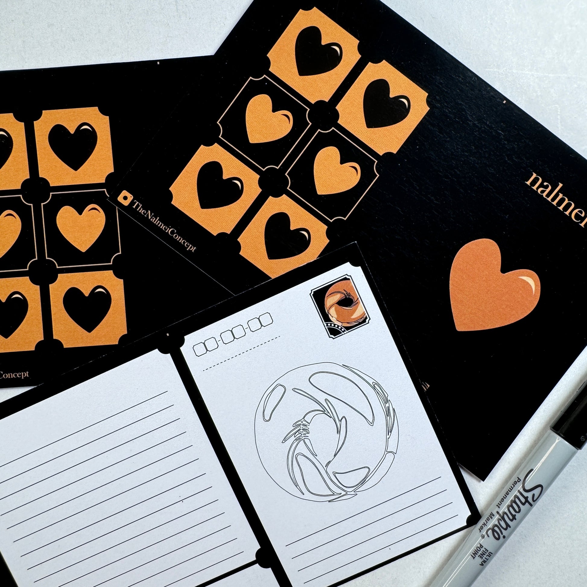 Black Postcard showing front and back with a sharpie | Nalmei